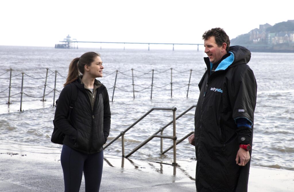 Ash talking to the actress Kelly before the start of filming of the SOS603 rescue line cabinet. The choppy waters of the Bristol channel and the historic Clevedon pier can be seen in the background.