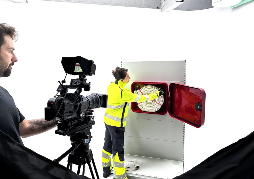 Rowan Pearce from the Bristol video company filming a close up of Elena removing a fire hose from the SOS300