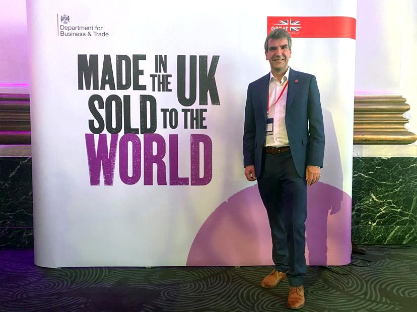 Guy Atkins at one of the two export events organised by the Department for business and trade this week. He is shown in front of the "made in the UK sold to the world banner.