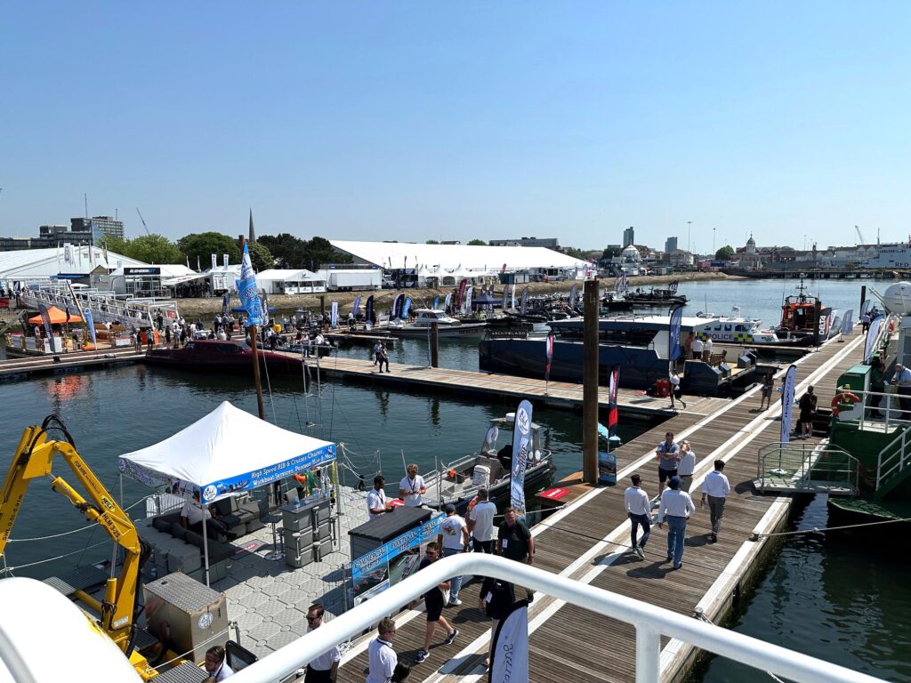 A photo taken at Seawork 2023. This was taken from a vessel showing the pontoons and exhibition halls in the background. The site is the Mayflower marina in Southampton. Jo Bird lifebuoy and rescue line cabinets are positioned around the pontoons in case anyone accidentally goes for a swim. With such a great record for good weather at this event, this might appeal to some!